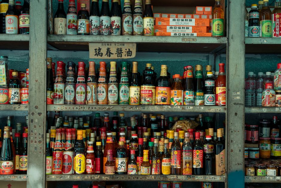 Rows of sauce and condiment bottles displayed on shelves
