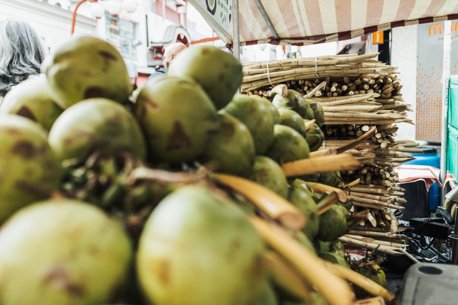 Pile of whole coconuts at an outdoor market stall