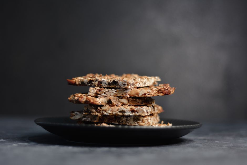 Stack of homemade granola bars on a dark plate