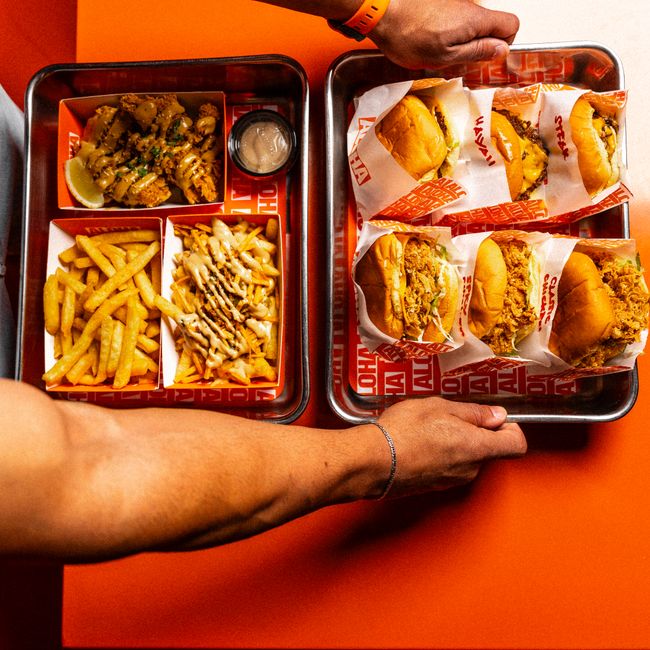 Close-up of mouthwatering burgers and fries on trays, perfect for a satisfying meal